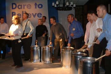 People having fun, playing instruments made from recycled materials in Catalyst team building activity Street Beat