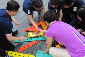 team collaborate to complete rat trap collaborative team building activity