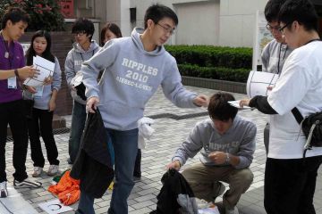 team collaborate to complete rags to riches charity team building event