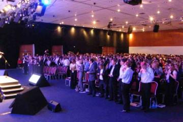 people in a conference room playing in team building activity harmonica harmony