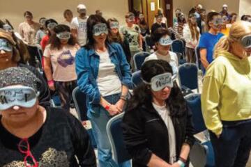 Team members wearing blindfolds during trust-based team building activity