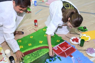 employees collaborate to complete bookworx creative team building activity