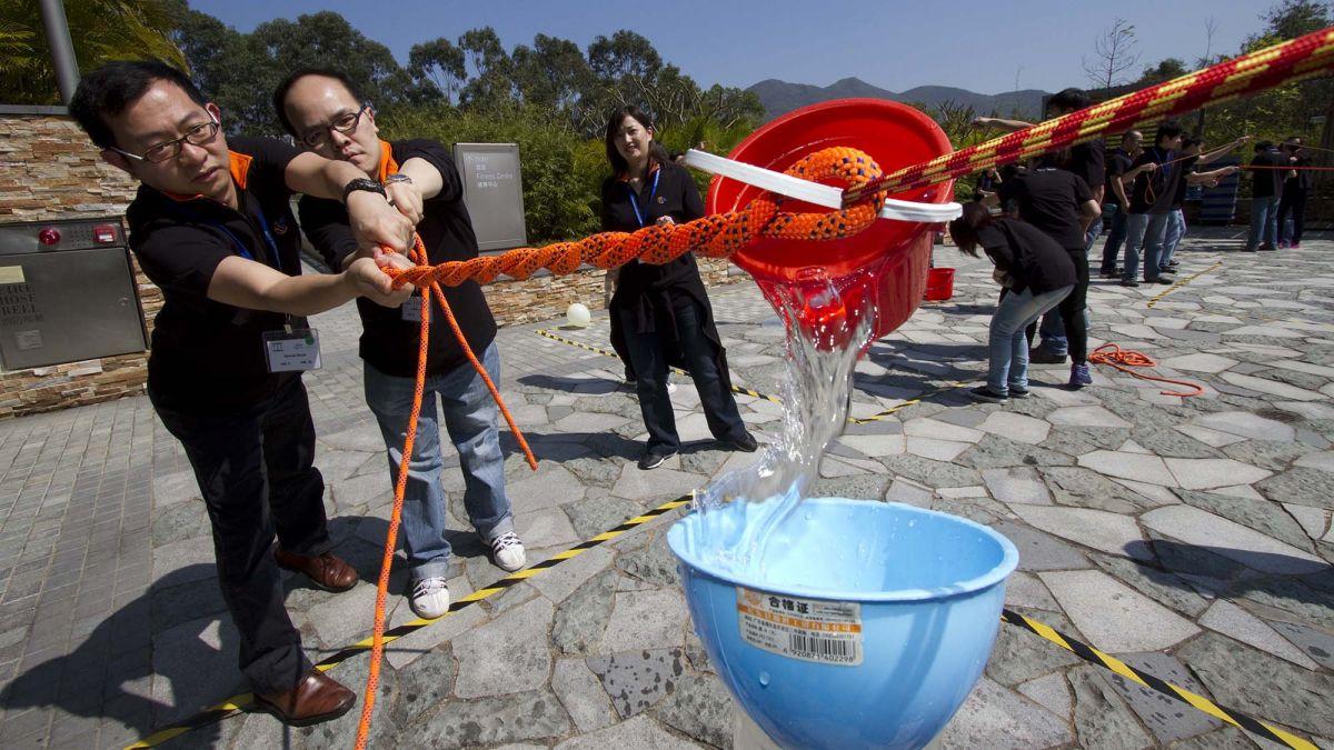 team collaborates in fun outdoor team building activity resized