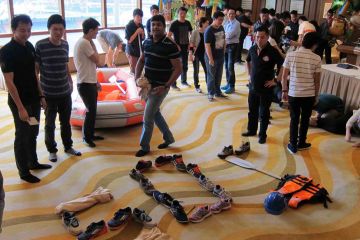 team collaborate to complete rags to riches charity team building event