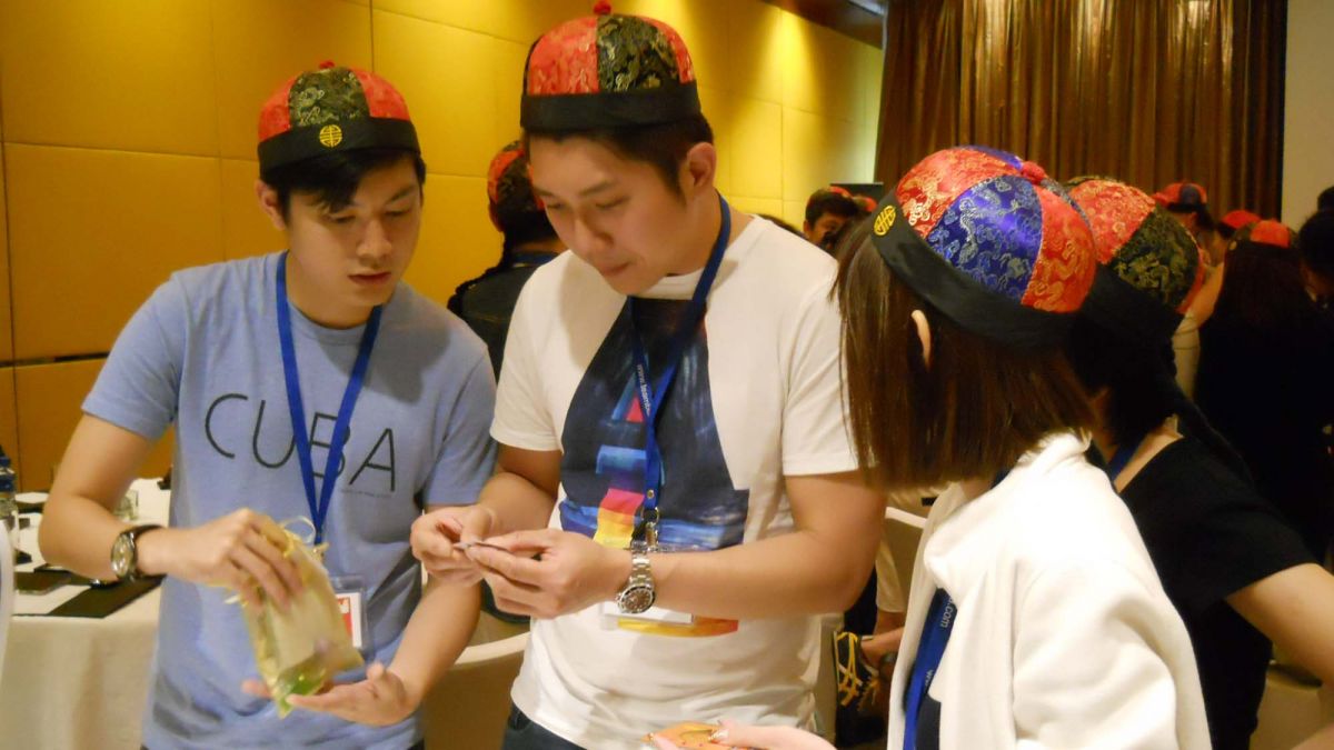 employees have fun collaborating to complete silk road team building activity