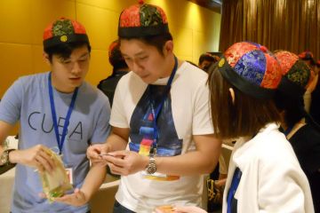 employees have fun collaborating to complete silk road team building activity