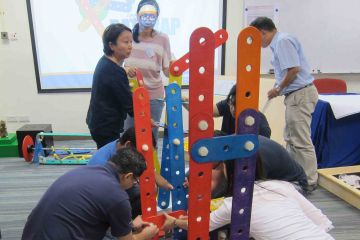 team collaborate to complete rat trap collaborative team building activity