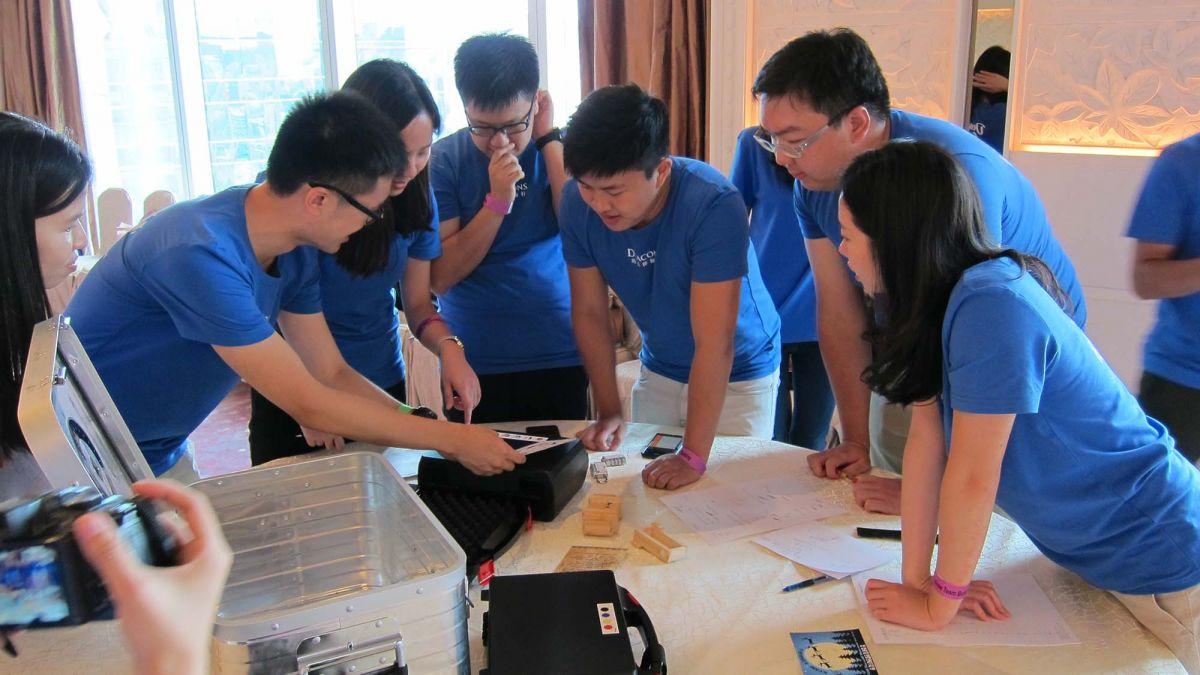 employees collaborate to complete fun team bonding activity team