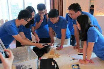 employees collaborate to complete fun team bonding activity team