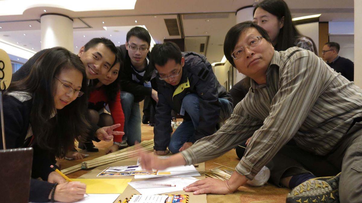 team works to complete team building creative challenge AI