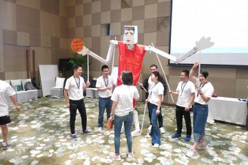 team collaborate to construct a puppet creative team building activity