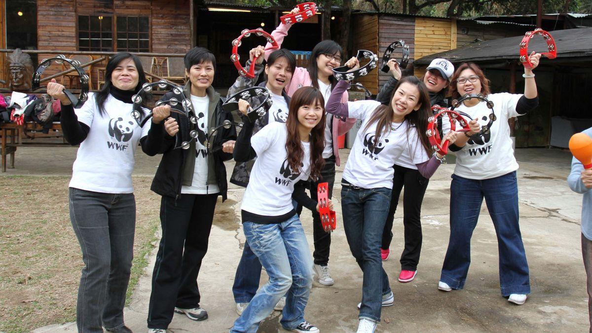 	team cheering at the camera for group picture music