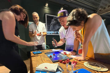 Teams negotiating artefact trades during the final challenge of Passport to Adventure.