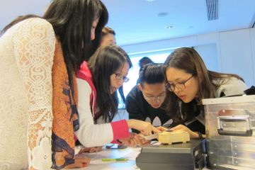 employees collaborating to complete beat the box team building activity