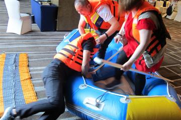 people saving a person in raft