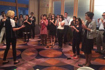 team practising to play the harmonica team building musical activity