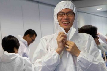 man wearing white overalls creative team building challenge