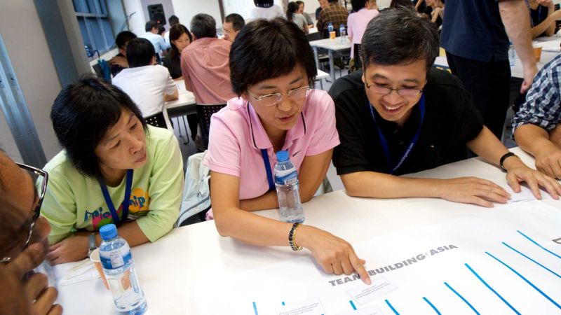 team collaborate in innovative team building game speak up speak out