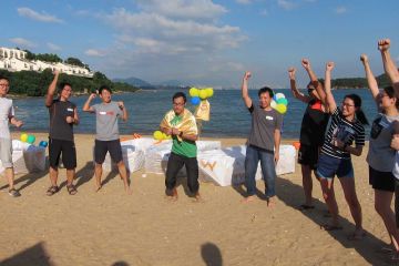 team cheering on the beach flat out afloat