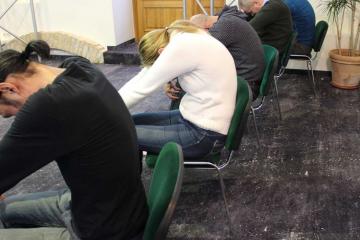 	employees stretching at the desk with head to toe activity wellness