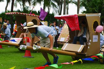 people racing the cardboard rickshaws fun team building activity