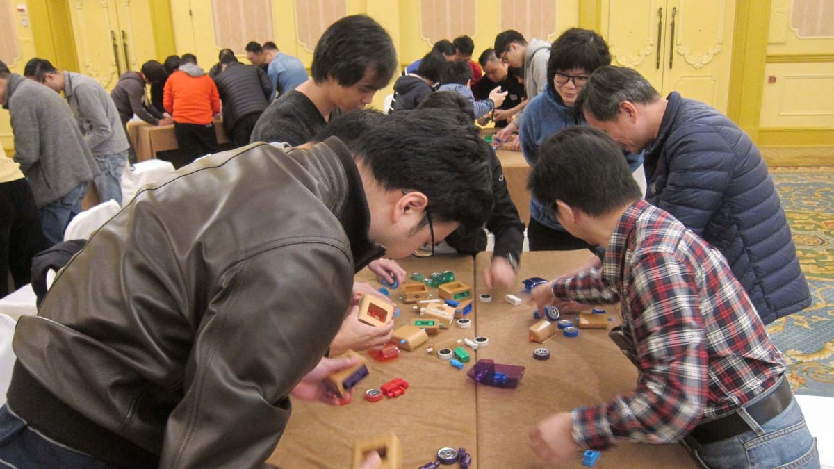 employees collaborate to complete team building challenge