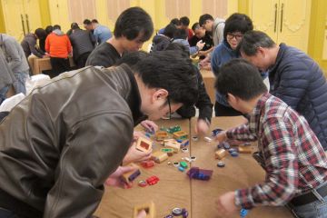 team work to complete challenging team building activity