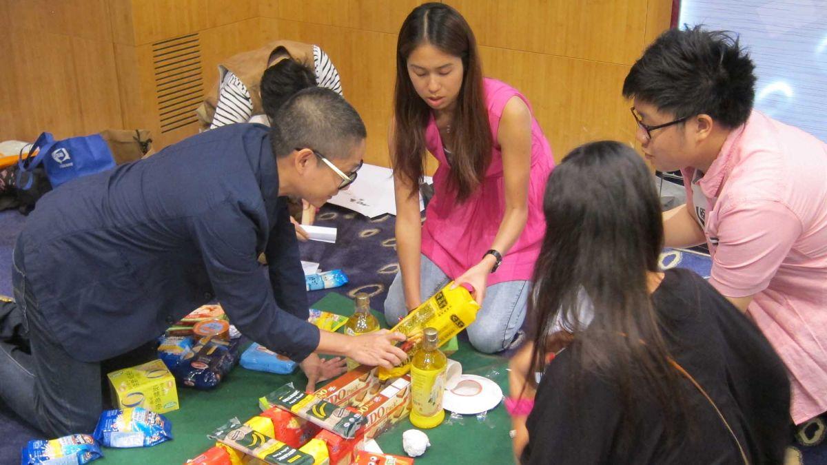 team collaborate to complete challenging team building game snacks