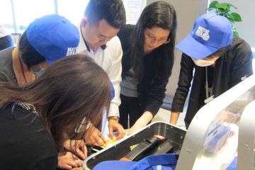 employees collaborating to complete beat the box team building activity