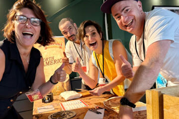 Participants celebrating together after completing the Passport to Adventure team building experience.