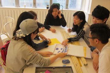 employees collaborate to complete bridging the divide creative team building activity