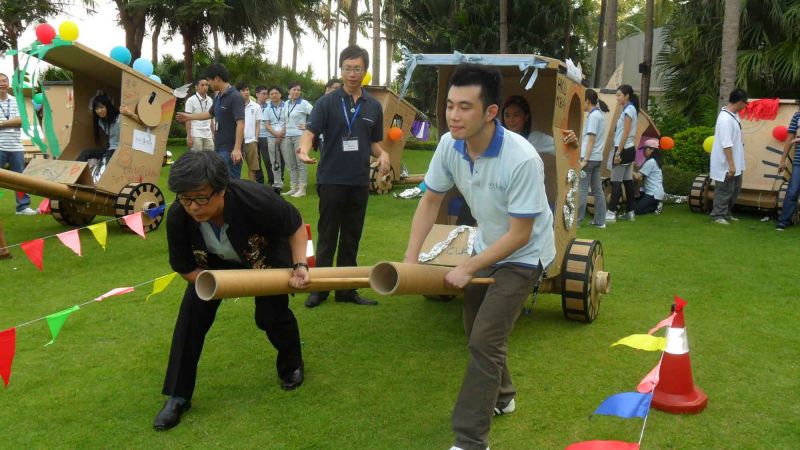 people racing the cardboard rickshaws fun team building activity