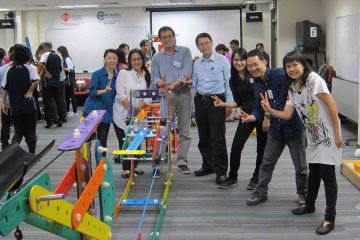 team collaborate to complete rat trap collaborative team building activity