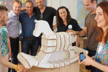 Participants building flat-pack rocking horse in collaborative team challenge