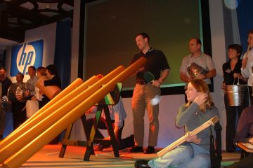 People having fun, playing instruments made from recycled materials in Catalyst team building activity Street Beat