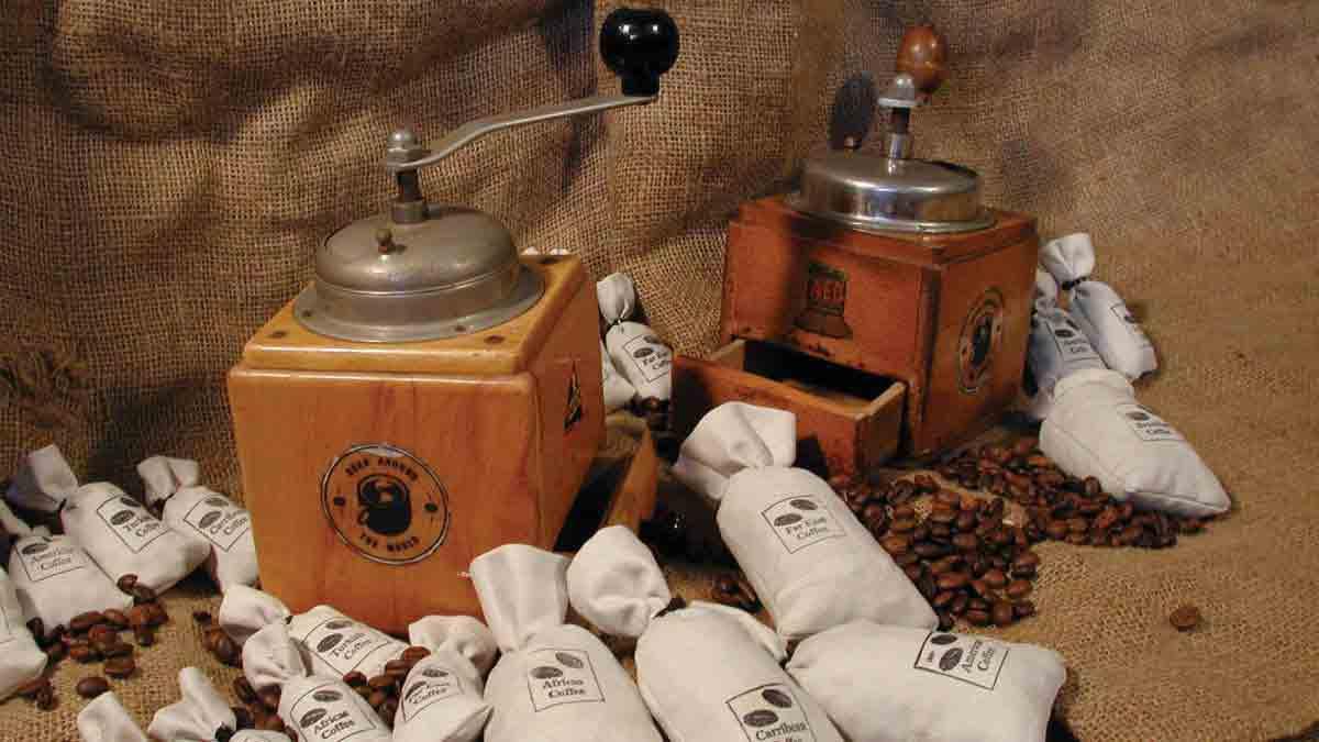 Coffee grinder and coffee bags laid out on a hessian bag ready for Catalyst team building activity Bean Around the World