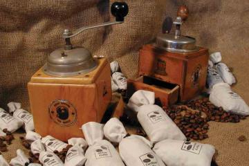 Coffee grinder and coffee bags laid out on a hessian bag ready for Catalyst team building activity Bean Around the World