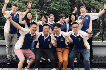 group of people cheering and smiling team bonding team