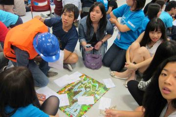 team collaborate to complete rags to riches charity team building event