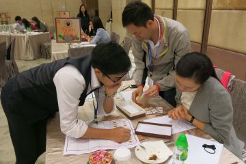 employees collaborating to complete bean around the world team building activity