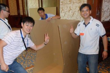 team collaborate to complete flat out rickshaw rally team building fun activity