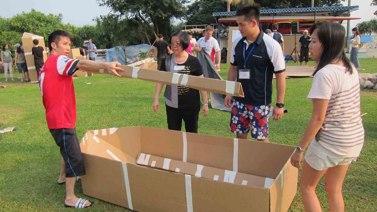 	team collaborate to build a cardboard racing boat flat out afloat team building challenge rabobank