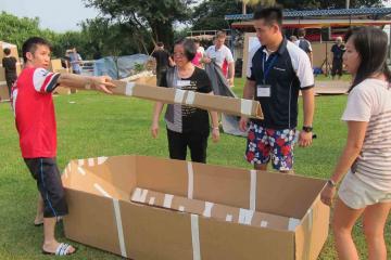 	team collaborate to build a cardboard racing boat flat out afloat team building challenge rabobank