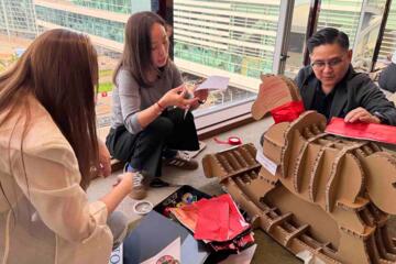 Participants building flat-pack rocking horse in collaborative team challenge