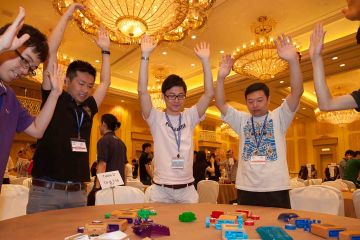 team collaborate to complete need for speed team building business game