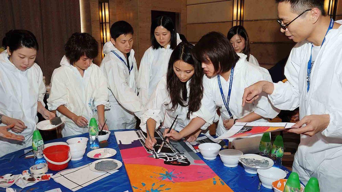 team collaborate to paint a big picture creative team building activity bp