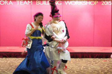 a man a woman dressed up for haute couture team building activity