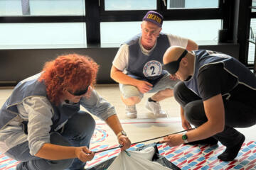 Business teams developing communication under pressure in a team building event