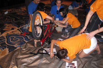 employees collaborate to complete building a dream team building activity