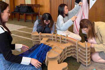 Group problem-solving while building cardboard horse structure